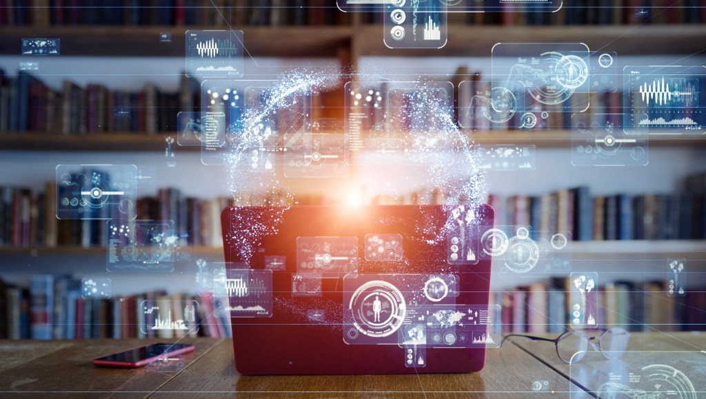 Picture of a high tech projector sitting in a library and emanating a range of graphs and charts.