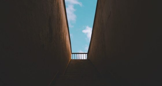 wedge of blue sky seen through a gap in concrete